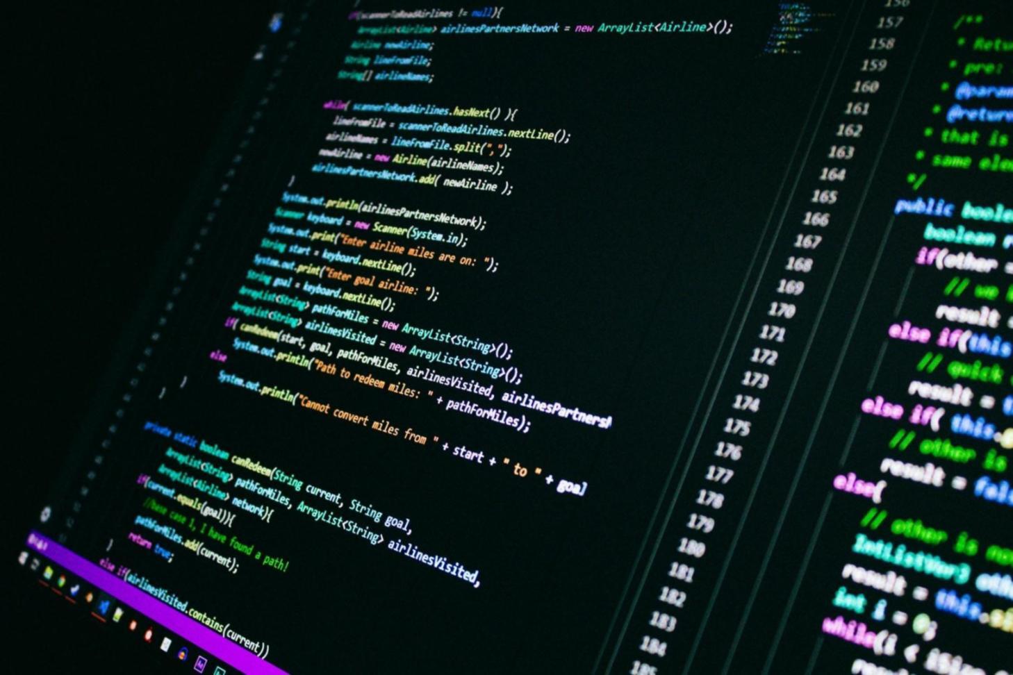 Mobile game development workspace showing code and game design elements